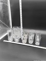 Front view of full set of glasses with rulers for scale