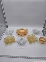 All seven bowls arranged with ruler for scale