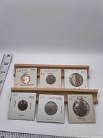 All six UK coins in flips on display stand