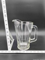 Side view of glass pitcher with ruler showing height just under 9 in