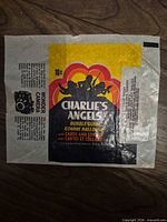 Full view of Charlie’s Angels trading card wrapper showing graphics, text and condition