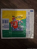 Full view of 1986 Topps football wax pack wrapper showing graphics, promotional text and wear