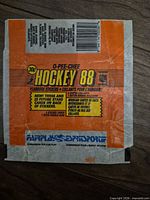 Front of 1988 O-Pee-Chee Hockey 88 sticker pack wrapper with branding, price, barcode and Fairplay logo visible