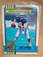 Front view of 1990 Topps Troy Aikman Super Rookie card in sleeve