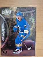 Front of 2021-22 Metal Universe John-Jason Peterka rookie card in sleeve