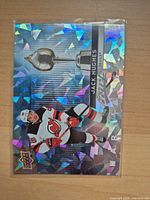 Front view of holographic Hart Attack insert card featuring Jack Hughes