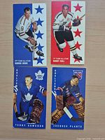 Fronts of four hockey trading cards showing Howe, Hull, Sawchuk, Plante