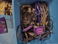 Top view of tote showing large quantity of mixed cables and power adapters