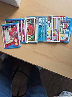 Stack of Chris Chelios trading cards showing mixed designs and brands