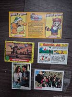 All six cards laid out on dark wood floor