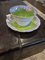 Teacup on saucer showcasing colors and trim