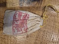 Front of cotton pouch with red printed graphic and yellow drawstring