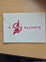 Front cover showing Piasecki logo, stain and crease