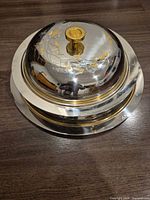 Domed silver-tone serving dish on base showing overall form and finish