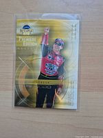 Front of 2002 Press Pass Eclipse Jeff Gordon gold foil promo card in sleeve