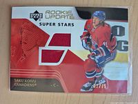 Front of card with player image, jersey swatch window, serial number