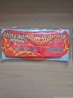 Front view of sealed red/orange flame design Shreddies foam glider plane showing graphics and packaging