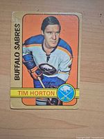 Front of Tim Horton Buffalo Sabres O-Pee-Chee card showing player image and team/logo