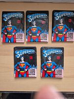 Front view of five sealed Superman The Movie trading card wax packs