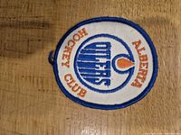 Front view of round Alberta Oilers embroidered patch showing full design and colors