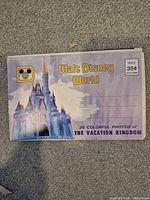 Front cover of Walt Disney World postcard foldout showing title, castle artwork and price
