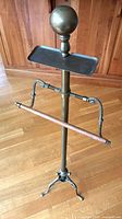 Full view of brass valet stand showing ball finial, tray, wooden trouser bar and tripod feet