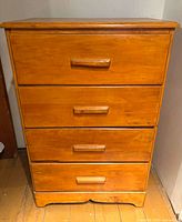 Front view of the four-drawer maple chest showing overall design, finish and hardware