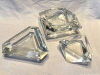 Three crystal ashtrays overall view