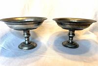 Front view of both pewter bowls on pedestals