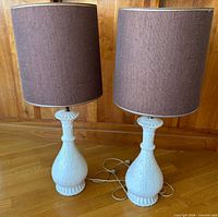 front view of both ceramic lamps with shades, cords visible