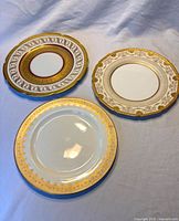 Front view of all three plates showing patterns and gold detailing