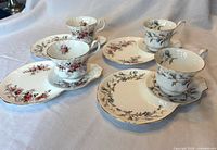All four Brigadoon teacup and snack plate sets displayed on flat surface