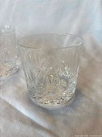 Close-up of two Waterford Lismore crystal whiskey tumblers showing cut pattern and clarity