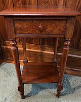 Full view of side table front showing drawer, legs, and shelf