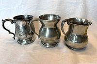 Front view of the three baluster tankards side by side