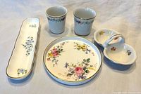 Top view of all five bone china pieces showing patterns and shapes