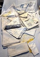 Pile of assorted embroidered napkins and handkerchiefs