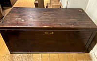 Front view of dark-stained cedar chest closed