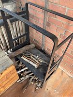 Front angle showing full steel rack structure with logs inside