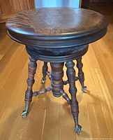 Full view of stool showing circular seat and legs