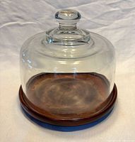 Overall view of teak cheese server with glass dome