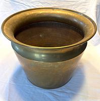 Angled front view showing hammered brass vessel and flared rim