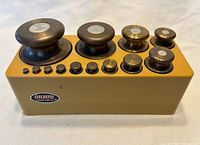 Top view showing all brass weights seated in mustard holder