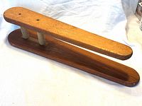 Top and side view of the wooden sleeve ironing board showing both planks and dowel supports