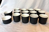 Front view of full set: 12 teacups, creamer and sugar bowl