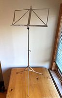 Full view of Wittner 961 folding music stand showing tripod base, adjustable shaft and lyre-topped sheet holder