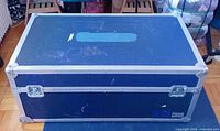 Top and front view of blue laminate equipment case showing overall form, aluminum edging, recessed latches