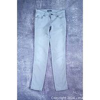 Full front view of grey slim-fit jeans laid flat