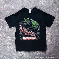 Front view of black Grave Digger graphic T-shirt laid flat