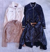Four jackets laid out showing styles and colors